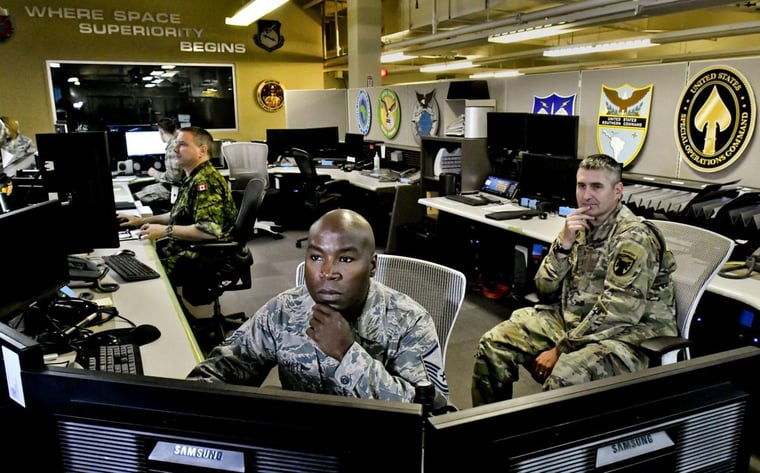 focused military man behind console Vandenburg AFB
