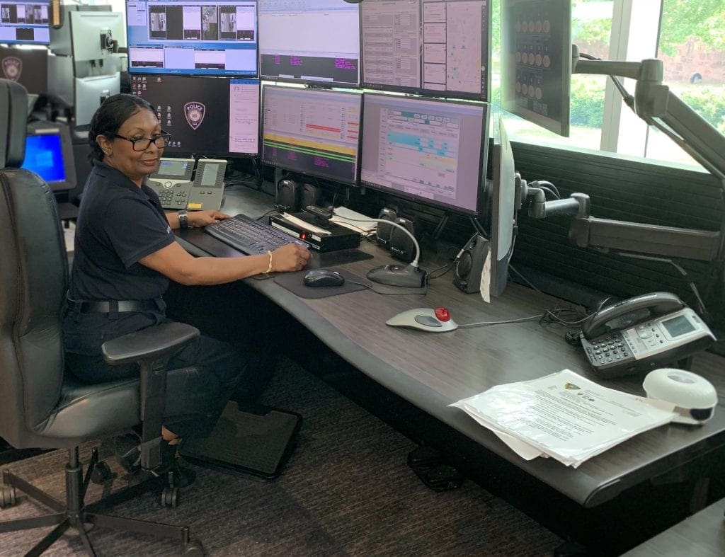 Dispatcher sits at Russ Bassett console in Yale University's Public Safety center